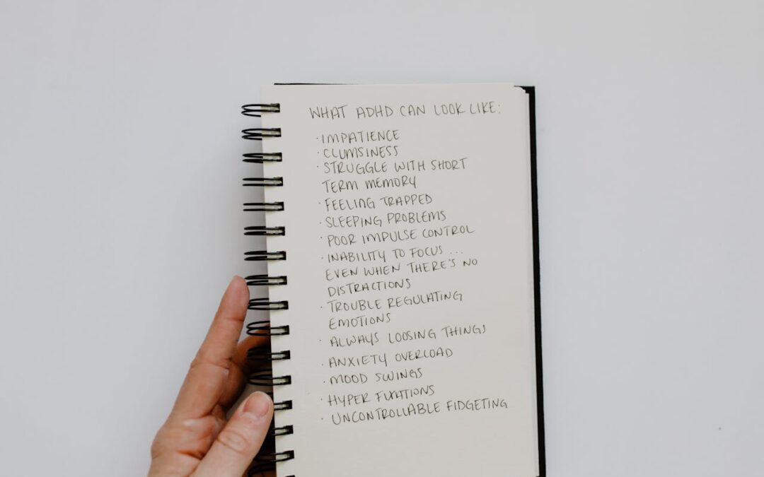 ADHD therapy Riviera Beach concept showing notebook listing common ADHD symptoms such as impatience, anxiety, and fidgeting.